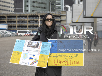 A woman with banners and slogan about the war. Hundreds of Ukrainians and Dutch people embarked on the Walk of Hope from the Central Station...