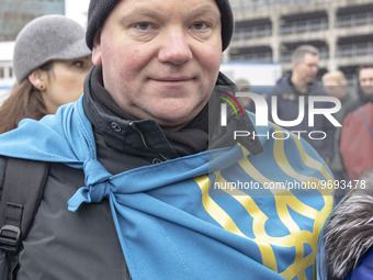 People are walking with the Ukrainian flags on their shoulders. Hundreds of Ukrainians and Dutch people embarked on the Walk of Hope from th...