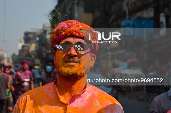 A man covered in colored powder poses for the camera during Holi festival celebration in Kolkata , India , on 5 March 2023 . Holi , also kno...
