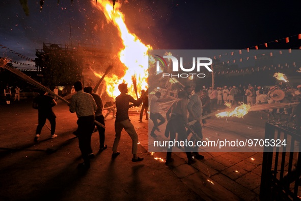People performs rituals during 'Holika Dahan', at City Palace in Jaipur, Rajasthan,India, Monday, March 6, 2023. 