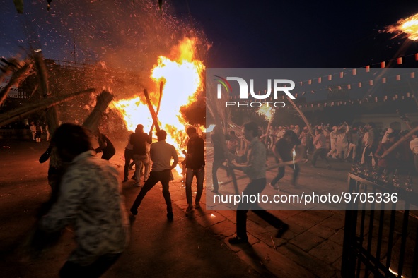 People performs rituals during 'Holika Dahan', at City Palace in Jaipur, Rajasthan,India, Monday, March 6, 2023. 