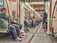 Commuters ride in a TTC subway car in Toronto, Ontario, Canada. (