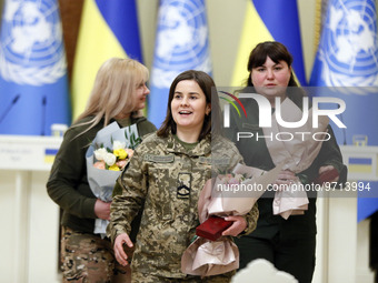 Ukrainian female soldiers are seen with flowers and state awards awarded by Ukrainian President to Ukrainian women from the army, rescuers,...