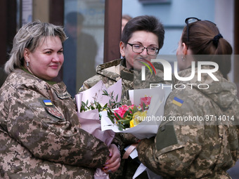 Ukrainian female soldiers are seen with flowers and state awards awarded by Ukrainian President to Ukrainian women from the army, rescuers,...