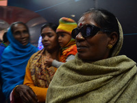 An indian woman look on a environment exhibit chart inside science express train at the Rambagh railway station in Allahabad on December 22,...