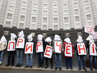 
Ukrainian activists who are suffering from HIV AIDS and hepatitis stand with bags on their heads and the noose around his neck as a symbol...