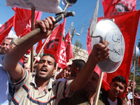 Palestinians take part in a march to mark the International Day of workers, or workers' holiday, in Gaza City, on May 1, 2014. (