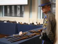 Connecticut State Troopers stand guard as museum staff presents artifacts during a repatriation ceremony for the return of a cache of fifty...