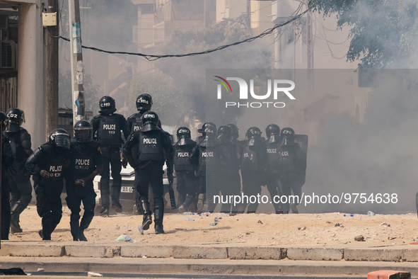 Clashes between police officers using teargas, and protesters throwing rocks, set barricades in fire, in Dakar on March 16, 2023. Security f...