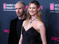 American singer and songwriter Adam Levine of American pop rock band Maroon 5 and wife/Namibian model Behati Prinsloo arrive at The Women's...
