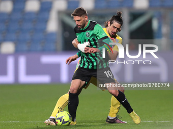 Domenico Berardi of U.S. Sassuolo Calcio competes for the ball with Arkadiusz Reca of Spezia Calcio during the Serie A match between U.S. Sa...