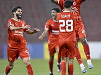 Youssef Msakni (2-R) of Al Arabi SC celebrate after scoring during the QNB Stars League match between Al Arabi SC and Al Sailiya SC at the G...