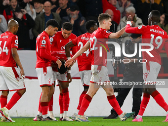 The Reds celebrate after Emmanuel Dennis of Nottingham Forest scored a goal during the Premier League match between Nottingham Forest and Ne...