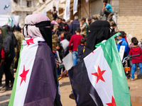 Syrians raise the flags of the revolution and chant in major demonstrations to celebrate the twelfth anniversary of the Syrian revolution ag...