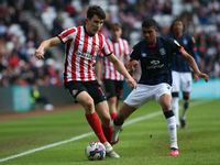 Sunderland's Luke O'Nien is under pressure from Luton Town's Cody Drameh during the Sky Bet Championship match between Sunderland and Luton...