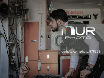 Nour, a 18-year-old Syrian man, helps a wounded man in a hospital, in a rebel-controlled area of Aleppo, on December 29, 2015. Nour lost his...