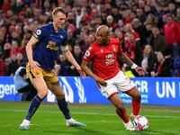 Andr Ayew of Nottingham Forest looking for options under pressure from Dan Burn of Newcastle United during the Premier League match between...