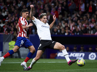 Hugo Duro of Valencia CF attempts a kick for score his goal during a match between Atletico de Madrid v Valencia CF as part of LaLiga in Mad...
