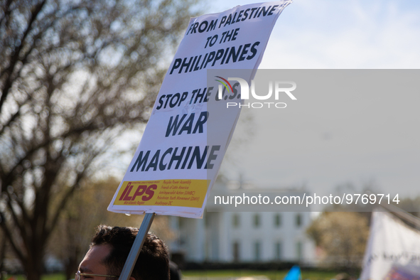 A demonstrator holds a sign during an anti-war protest in Washington, D.C. on March 18, 2023. The protest, organized by the Answer Coalition...