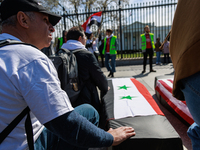 Demonstrators place symbolic body caskets on the ground in front of the White House during an anti-war protest in Washington, D.C. on March...