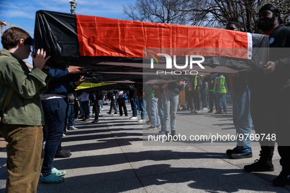 Demonstrators carry symbolic body caskets after placing them on the ground in front of the White House during an anti-war protest in Washing...