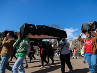Demonstrators carry symbolic body caskets before placing them on the ground in front of the White House during an anti-war protest in Washin...