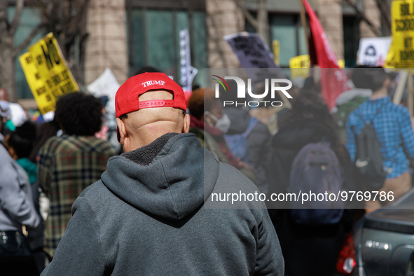 A person wears a hat bearing the name of former U.S. President Donald Trump as they watch an anti-war protest in Washington, D.C. on March 1...