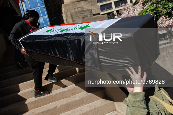 Demonstrators carry symbolic body caskets into The New York Avenue Presbyterian Church during an anti-war protest in Washington, D.C. on Mar...