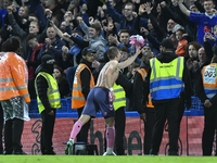 Vitaliy Mykolenko of Everton giving his shirt to an Everton fan after the Premier League match between Chelsea and Everton at Stamford Bridg...