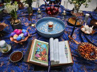 Traditional items adorn a Haft Sin (Haft Seen) (an arrangement of seven symbolic items that all begin with the letter S in Farsi) during Nev...