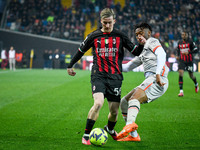 Milan's Alexis Saelemaekers in action against Udinese's Destiny Iyenoma Udogie during the italian soccer Serie A match Udinese Calcio vs AC...
