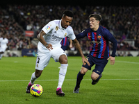 Eder Militao centre-back of Real Madrid and Brazil and Gavi central midfield of Barcelona and Spain compete for the ball during the La Liga...