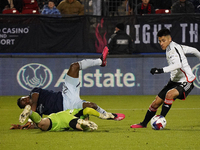 March 18, 2023, Frisco, United States: Sporting KC forward Willy Agada falls on top of FC Dallas goalkeeper Maarten Paes during second half...