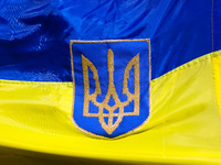 Coat of arms of Ukraine is seen on an Ukrainian flag during a daily demonstration of solidarity with Ukraine at the Main Square on 389th day...