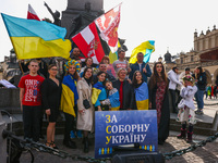 Ukrainian citizens and supporters attend a daily demonstration of solidarity with Ukraine at the Main Square on 389th day of Russian invasio...