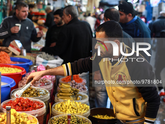 A Palestinian pedlar sells pickles in Al-Zawya old market in Gaza City, in preparation of the upcoming Muslim holy fasting month of Ramadan...