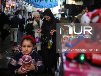 Palestinians shop for decorations in Al-Zawya old market in Gaza City, in preparation of the upcoming Muslim holy fasting month of Ramadan o...