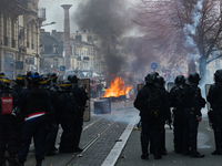 Anti-riot police officers use teargas, facing the demonstrators in a demonstration on a national action day, a week after the government pus...