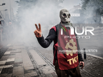 Turkish protester wearing a gas mask during clashes with riot police who prevent demonstrators from reaching Taksim Square in Istanbul for a...