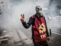 Turkish protester wearing a gas mask during clashes with riot police who prevent demonstrators from reaching Taksim Square in Istanbul for a...