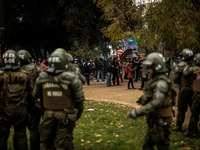 Demonstrators clash with the police during a march held in the framework of May Day on May 1, 2014 in Santiago, Chile. (
