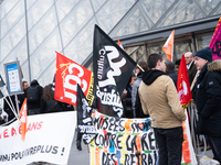 Striking employees of the Louvre Museum in Paris set up a picket line on March 27, 2023 to prevent the opening of the museum in protest agai...