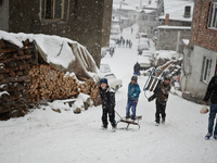Bulgarian Mohammedan boys or also called pomaks play with their sleds as heavy snow falls in the village of Ribnovo, Blagoevgrad on January...