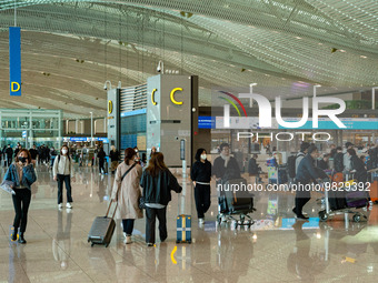 Passengers with luggages walk and wait check-in at Incheon International Airport on March 30, 2023, South Korea.According to Incheon Intern...