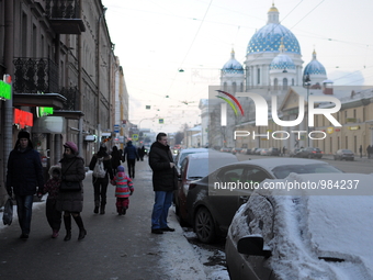 People walk along the avenue with views of the Trinity Cathedral in St. Petersburg. Russia, Tuesday, January 5, 2015 Temperatures dipped to...