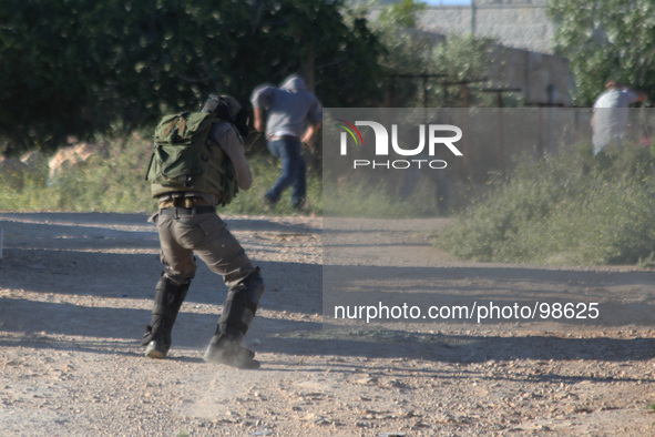 Ramallah, West Bank, Palestinian Territories, May 02, 2014: Israeli soldier hits the rubber bullets at Palestinian protesters during a prote...