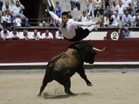 A ''recortador'' jumps over a bull during a bullfight in Madrid, Spain, Friday, May 2, 2014. 'Recortadores' is a bloodless type of bullfight...
