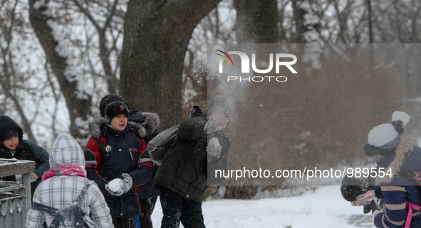 Kids plays a snowball at a park downtown Kyiv, on January 9, 2016. Storm warning announced in Ukraine by Hydrometeorological Center 