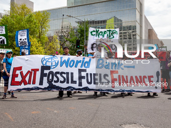 Climate activists participate in a rally and march at World Bank headquarters during its spring meetings with the International Monetary Fun...