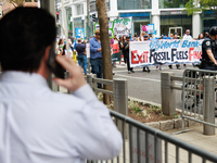 A man speaks on his phone outside of the 2023 IMF-World Bank meetings in Washington, D.C. on April 14, 2023 as climate change demonstrators...